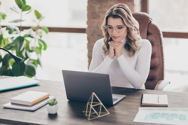 woman in her office working on laptop