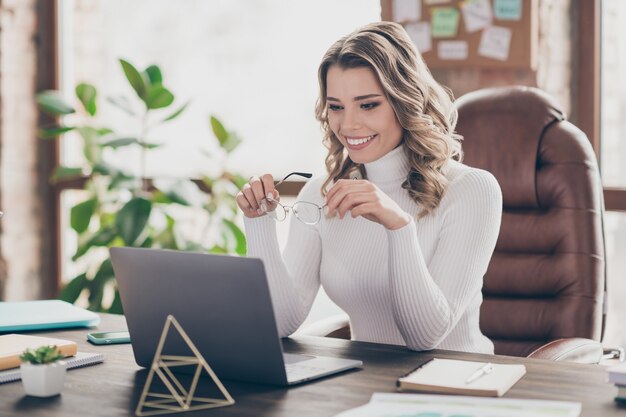 woman in her office working on laptop