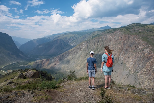 Woman an her son on the viewpoint of valley of the river of Chulyshman. Altai mountains, Russia