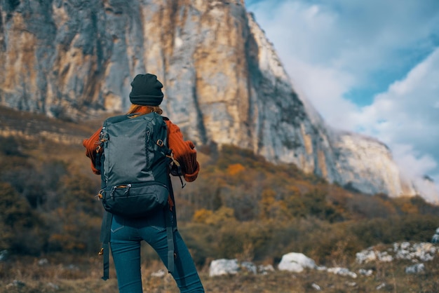 Woman hiker admire nature rocky mountains travel High quality photo