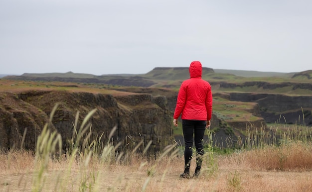 Woman hiker at american nature landscape during cloudy day