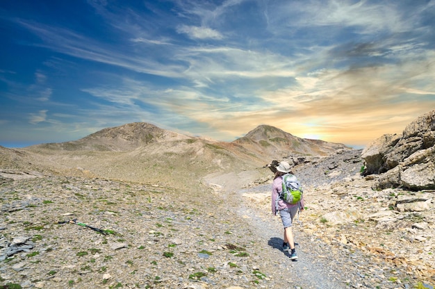 A woman hiker on a high mountain trail