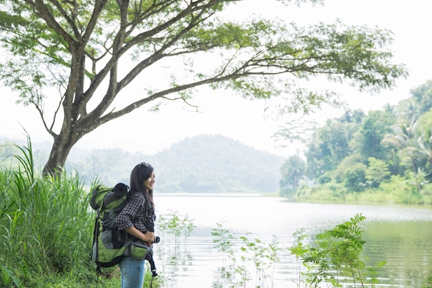 Woman hiker hiking on mountain trail