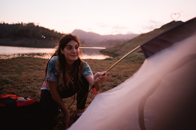 Woman hiker prepare make a tent