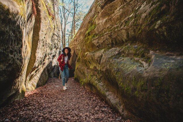 Woman hiker with backpack walking by trail