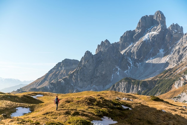 woman hiking on footpath in alpine landscape bischofsmutze filzmoos austria