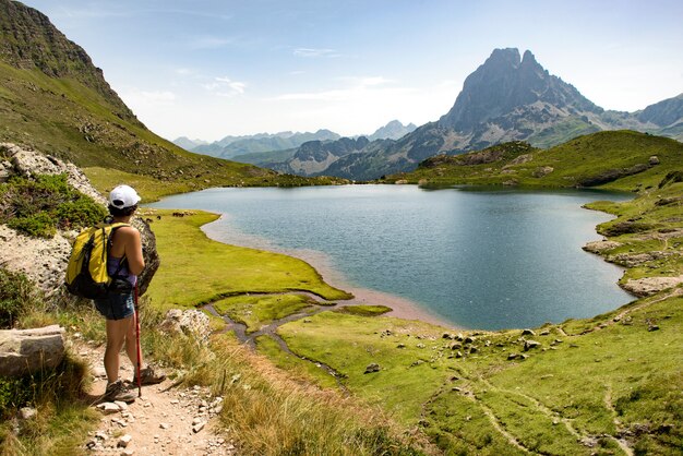 Woman hiking near a mountain lake