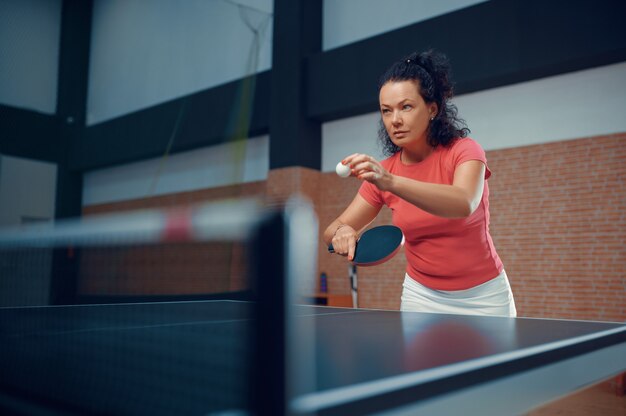 Woman hits ball at the wall