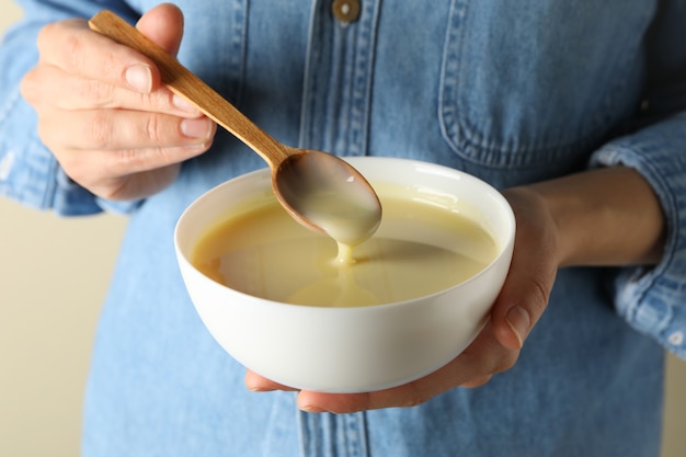 Woman hold bowl with condensed milk