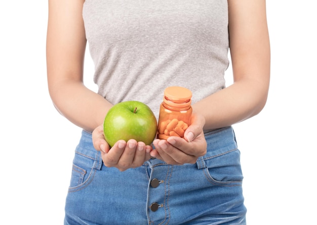 woman hold a green apple with medicine bottle isolated on white background.