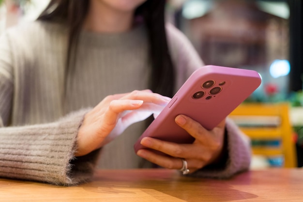 Woman hold with mobile phone in restaurant