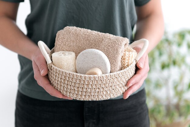 woman hold woven basket with natural body care products