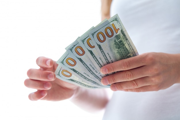 Woman holding american dollars banknotes. Money counting and distribution.