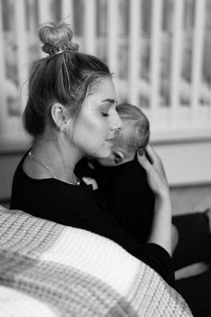 A woman holding a baby in her arms A Mother's Love A Tender Moment Between a Woman and Her Baby