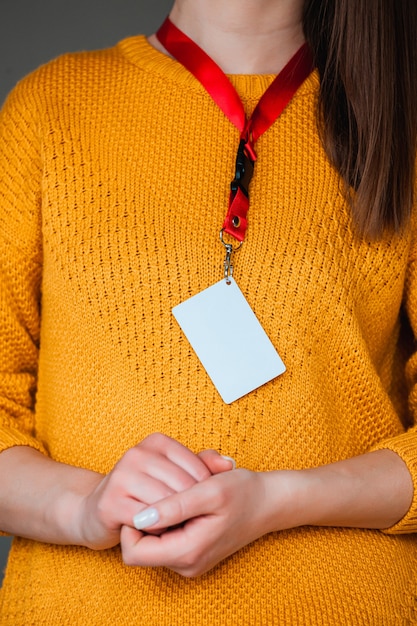 Woman holding badge name tag, with blank space mock up