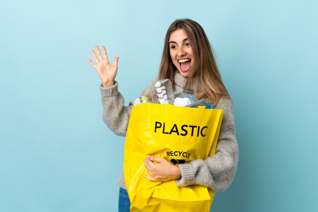 Woman holding a bag full of plastic bottles