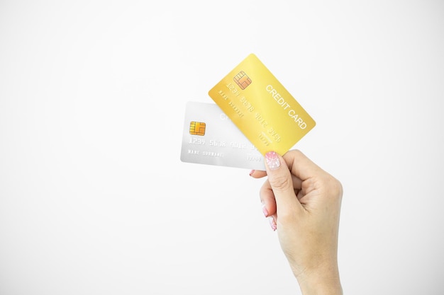 Woman holding bank business credit card on white background Female hand holding bank credit card gold Paying using credit card shopping lifestyle copy space