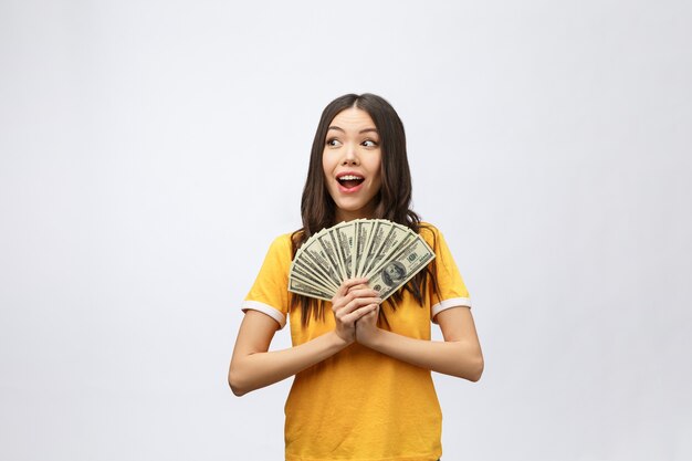 Woman holding bank money note. Pretty young model showing cash