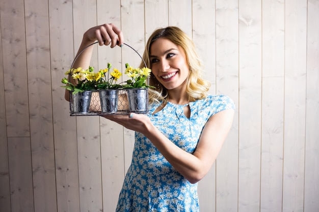 Woman holding a basket of plant pots