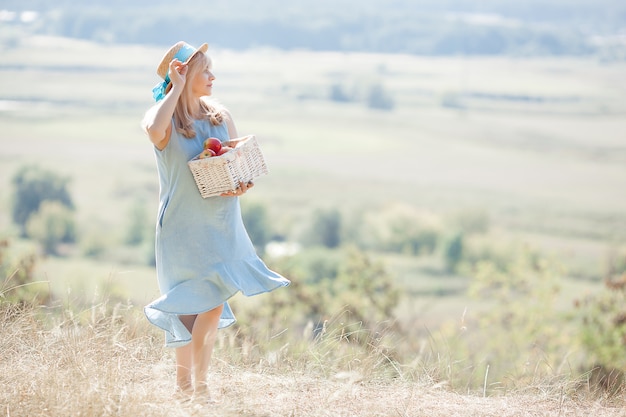 Woman holding a basket with apples