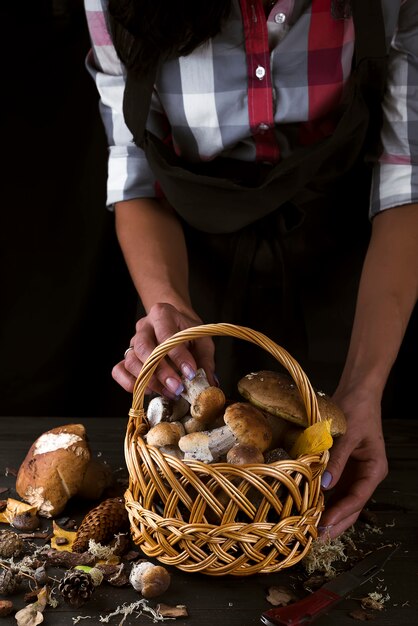 Woman holding a basket with mushrooms