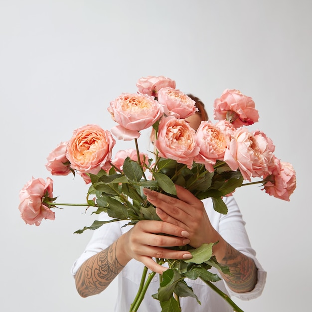 woman holding a beautiful bouquet of pink roses, valentines day