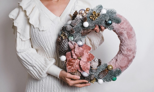 Woman holding beautiful christmas wreath