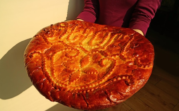 Woman Holding a Beautiful Decorated Large Gata Tasty Sweet Filled Armenian Traditional Bread