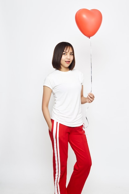 Woman holding big red balloon heart 