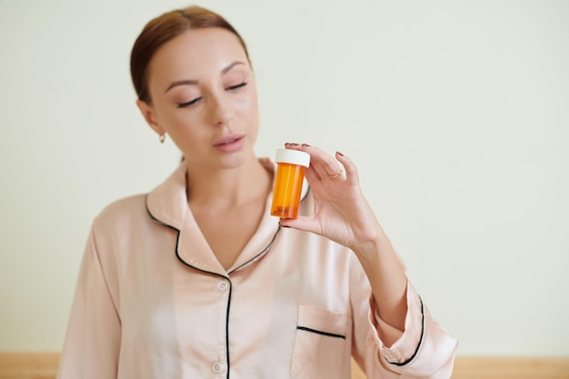 Photo woman holding birth control pills