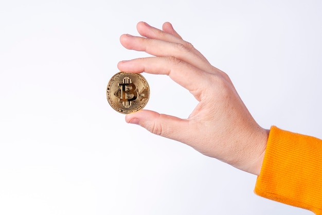 Woman holding Bitcoin (BTC) physical currency, Cryptocurrency concepts on white background.