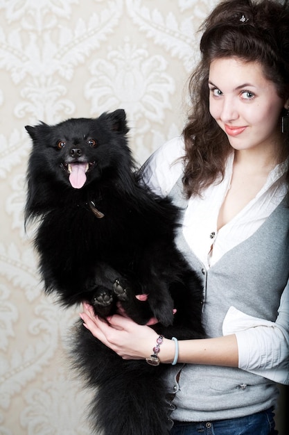 Woman holding black dog