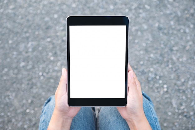 Woman holding black tablet pc with blank white screen