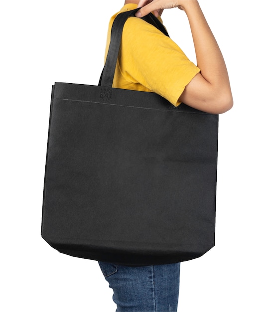 Woman holding blank black fabric canvas bag isolated