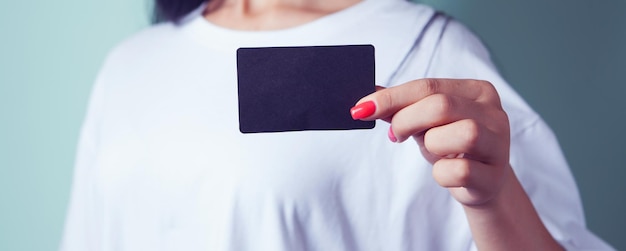 Woman holding blank black paper