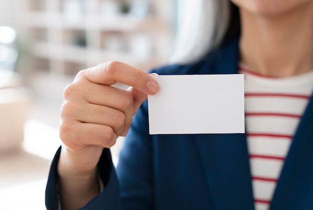 Woman holding blank business card