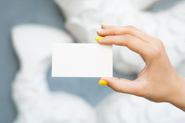 A woman holding a blank card in her hand