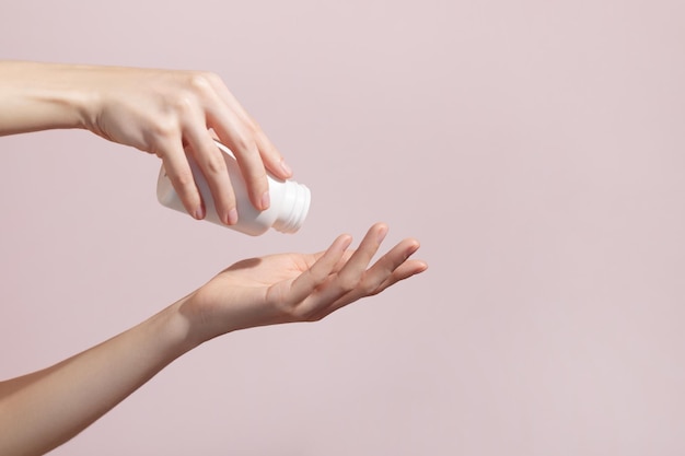 Woman holding blank white plastic tube in hands taking emergency supplements or antibiotic Mockup