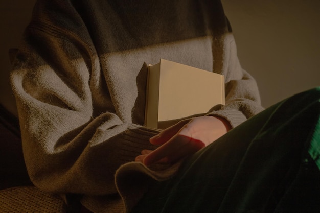 Woman holding a book in sunlight