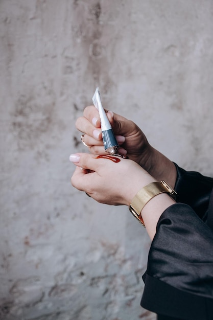 A woman holding a bottle of nail polish.