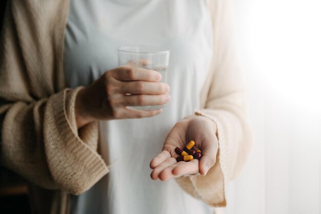 Photo woman holding bottle with pills on hand going to take medicaments prescribed by his physicianxa