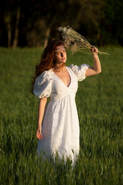 Woman holding bouquet full shot