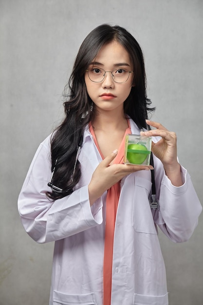 A woman holding a box of green candle in her hand