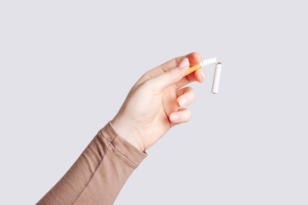 woman holding broken cigarette in hand woman refusing cigarettes