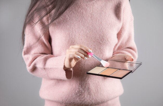 Woman holding brush and highlighter