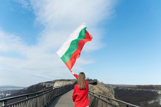 Woman holding bulgarian flag outside