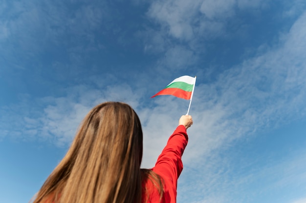 Woman holding bulgarian flag outside