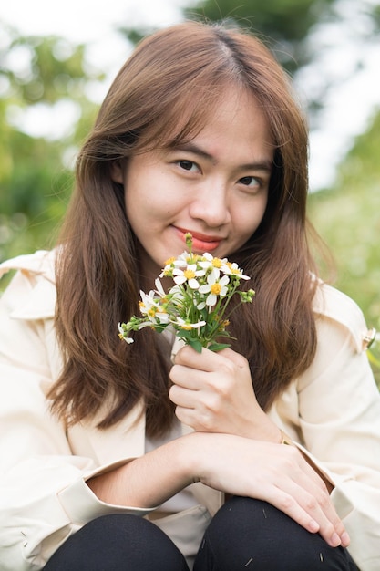 A woman holding a bunch of flowers in her hand