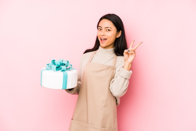 Woman holding a cake in studio