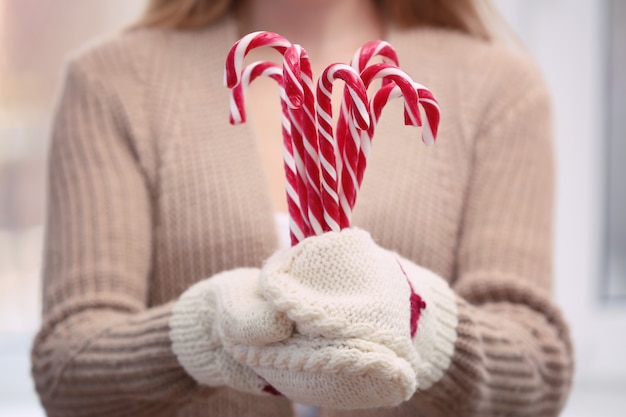 Woman holding candy canes, closeup